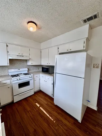 a kitchen with a white cabinets and white appliances