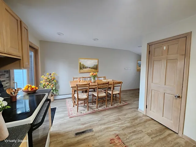 a dining room with furniture and wooden floor