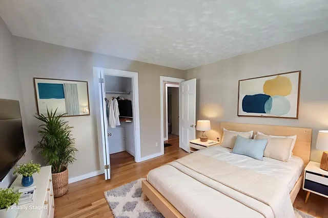 a bedroom with a bed and a potted plant