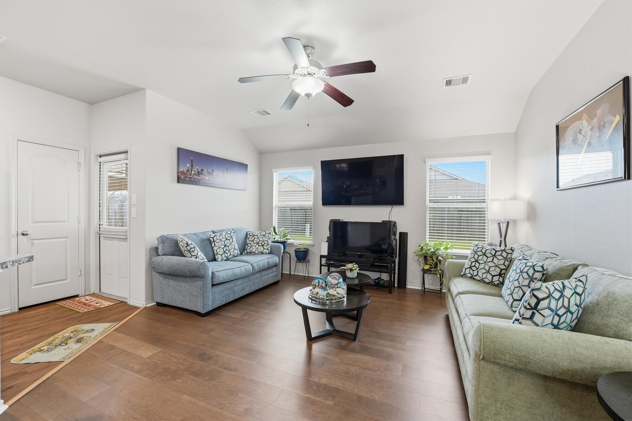 15455 Rancho Joya Way Houston, TX 77049 - Photo 9 of 20 a living room with furniture a fireplace and a flat screen tv