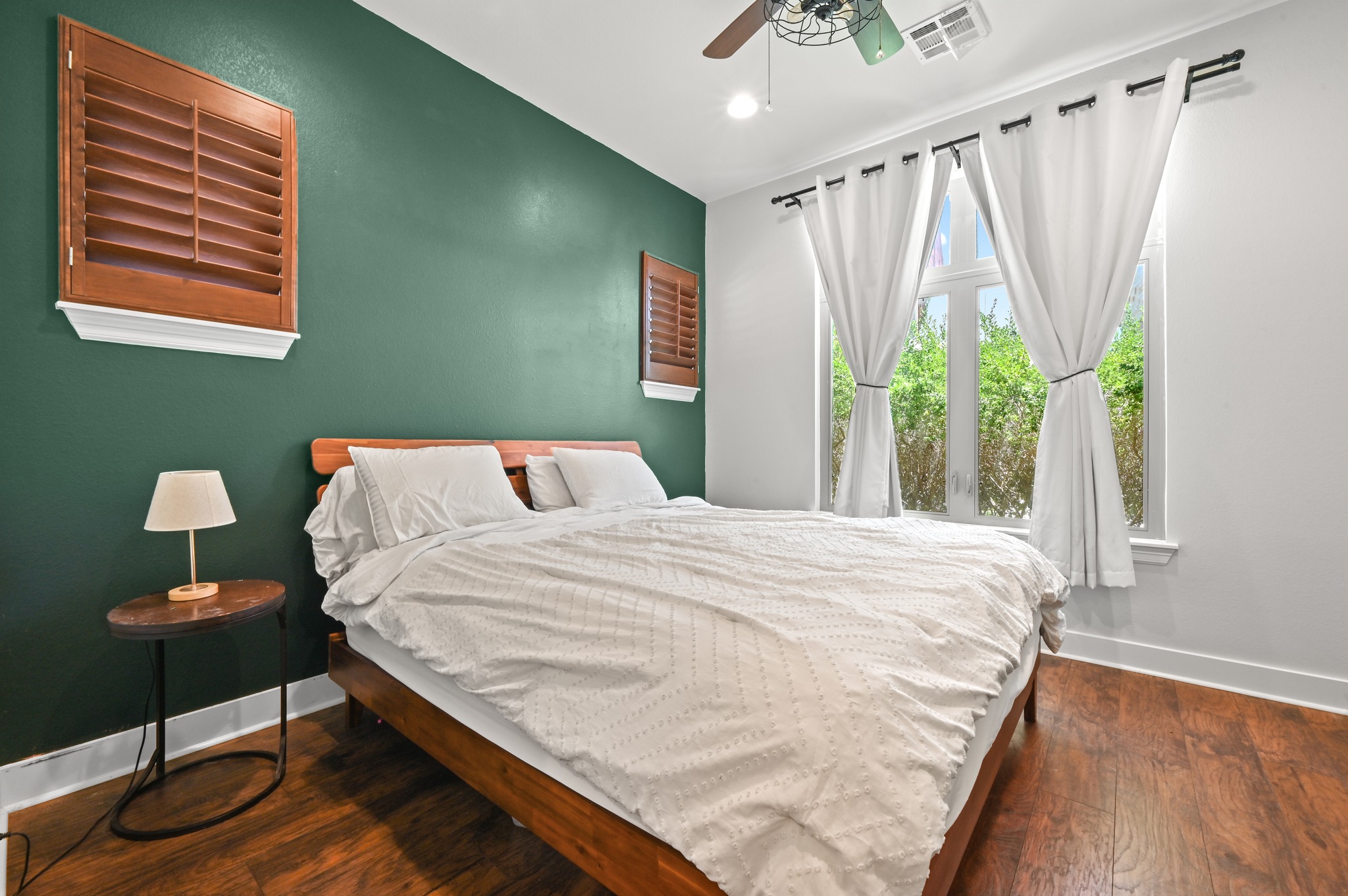592 Farm To Market 967, Unit B Buda, TX 78610 - Photo 15 of 26 Thoughtfully designed for comfort and relaxation, the spacious primary suite is filled with natural light and showcases rich hardwood floors and timeless plantation shutters.