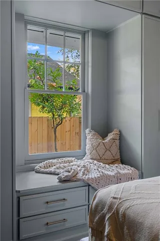 a bedroom with a bed and a window