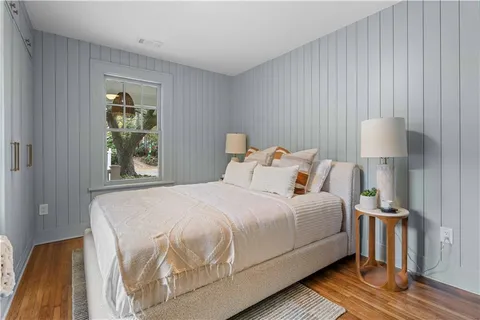 a bedroom with a bed and a night stand