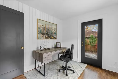a view of a workspace with furniture and a window