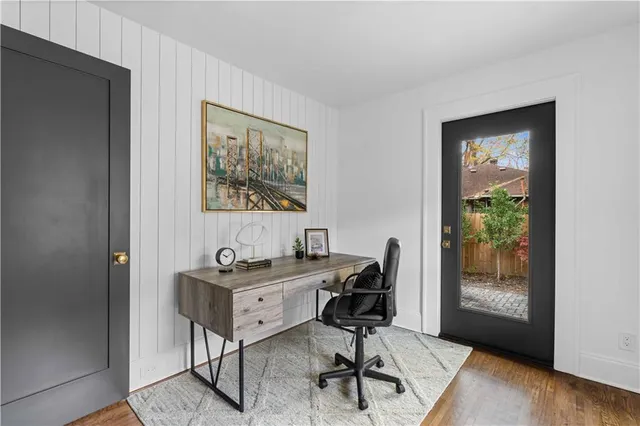 a view of a workspace with furniture and a window