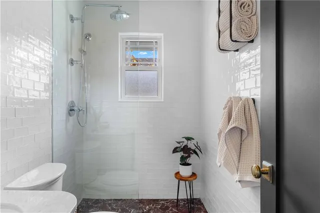 a bathroom with a toilet sink and shower