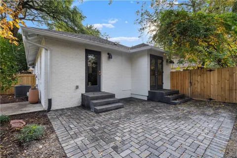 a view of a house with a sink and wooden fence