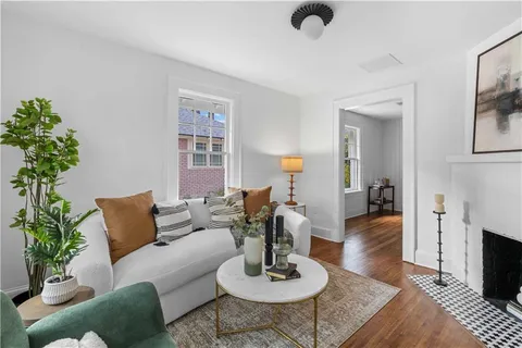 a living room with furniture and a potted plant