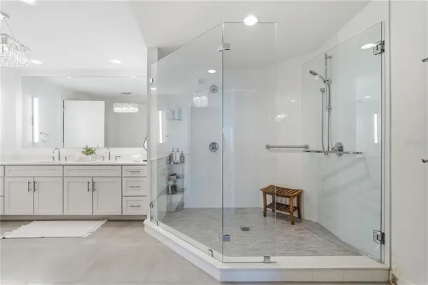 a spacious bathroom with a granite countertop sink a mirror and a potted plant
