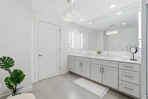 a bathroom with double sink and a mirror