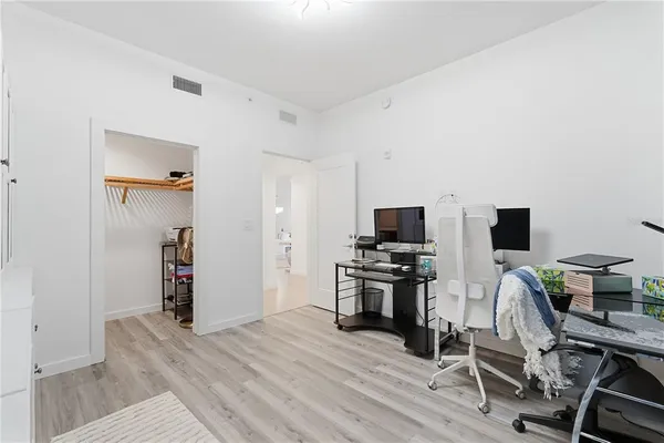 a bathroom with a toilet a sink a mirror a bathtub and vanity