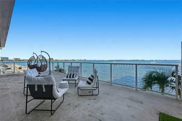 a roof deck with a table and chairs