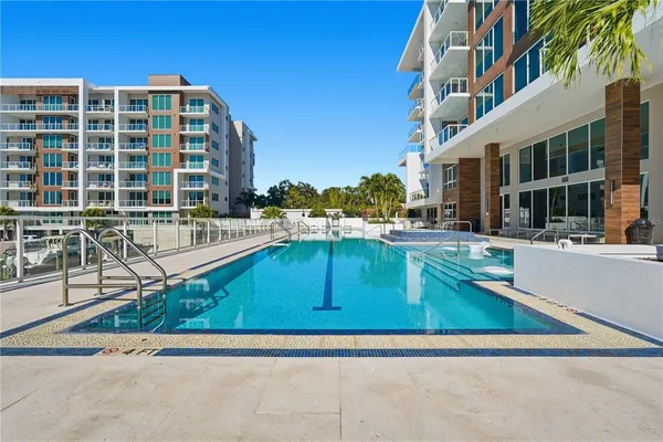 a swimming pool with outdoor seating and yard