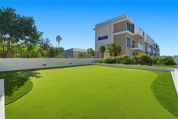 a view of a lake from a balcony with furniture
