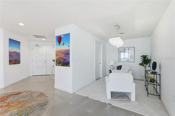 a living room with furniture and a dining table with wooden floor