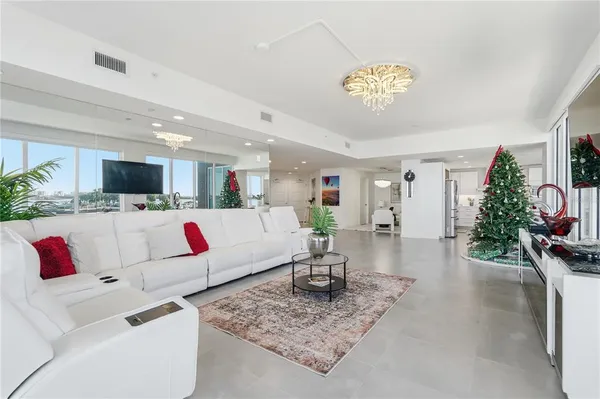 a living room with kitchen island furniture and a chandelier