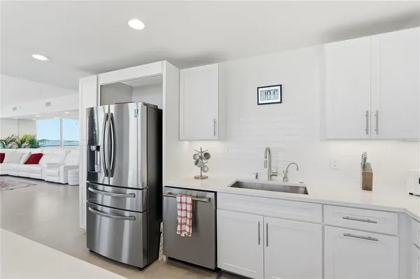 a kitchen with stainless steel appliances a refrigerator and sink