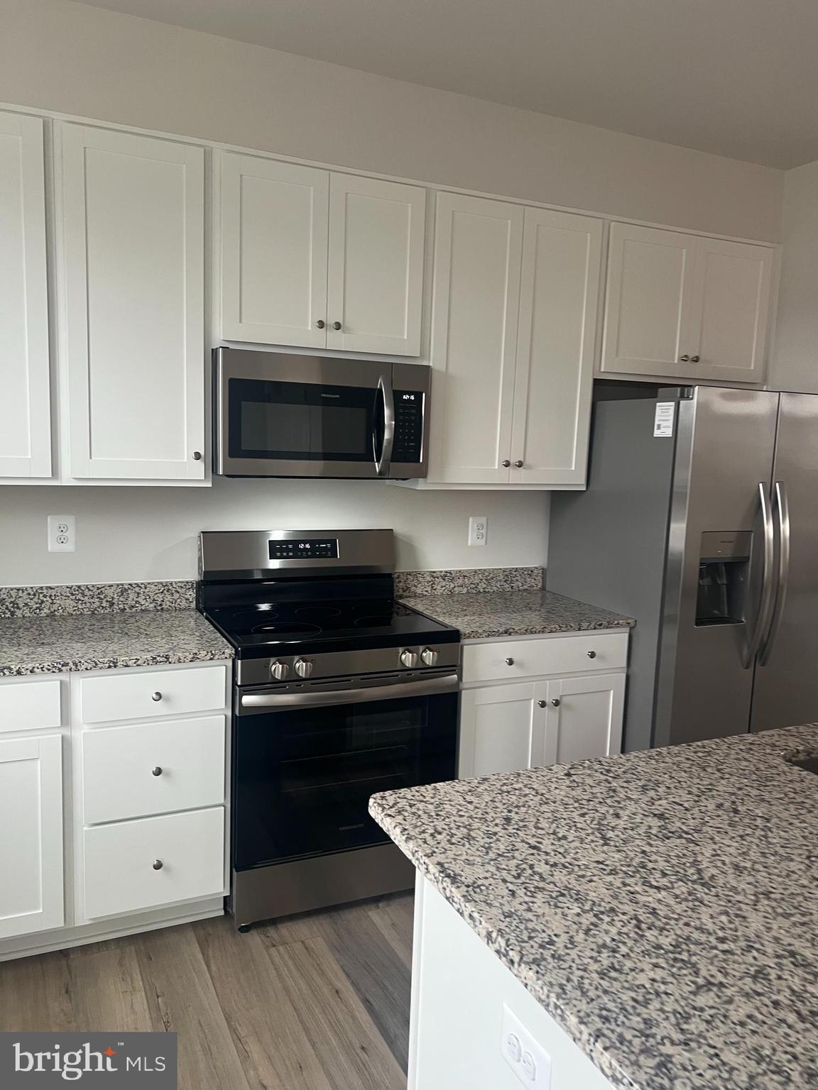 238 Cooperage Road Inwood, WV 25428 - Photo 11 of 27 a kitchen with granite countertop a sink stove and refrigerator