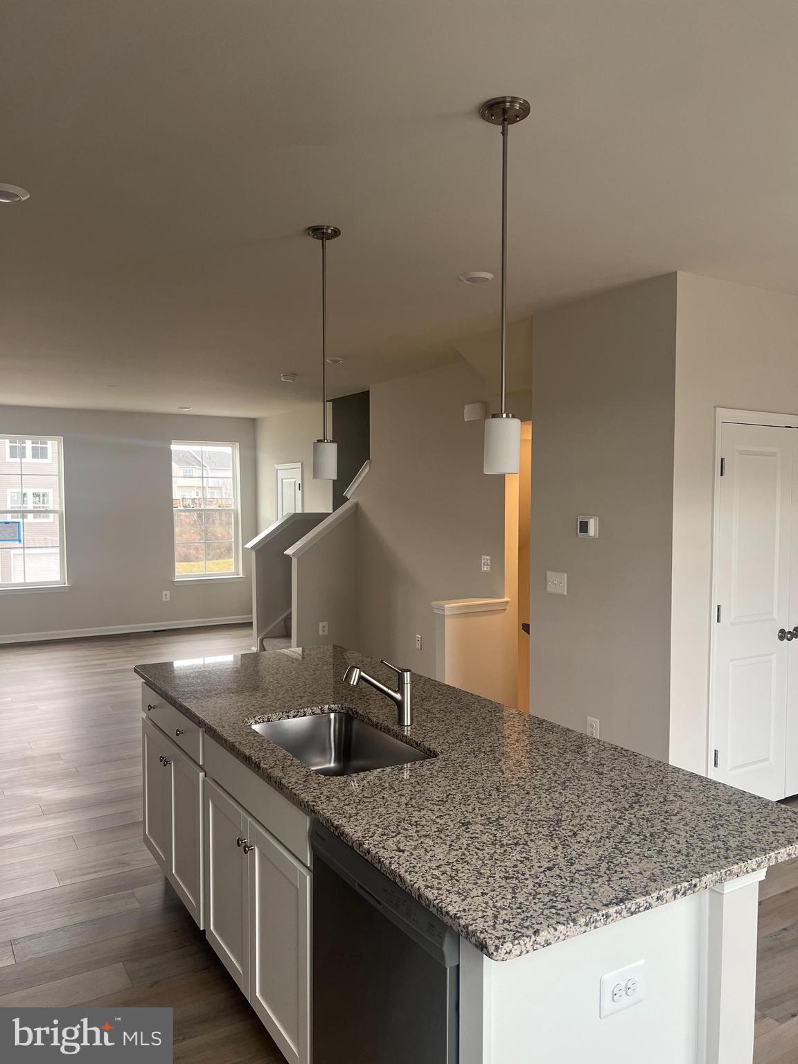 238 Cooperage Road Inwood, WV 25428 - Photo 13 of 27 a kitchen with stainless steel appliances granite countertop a sink a stove and a wooden floor