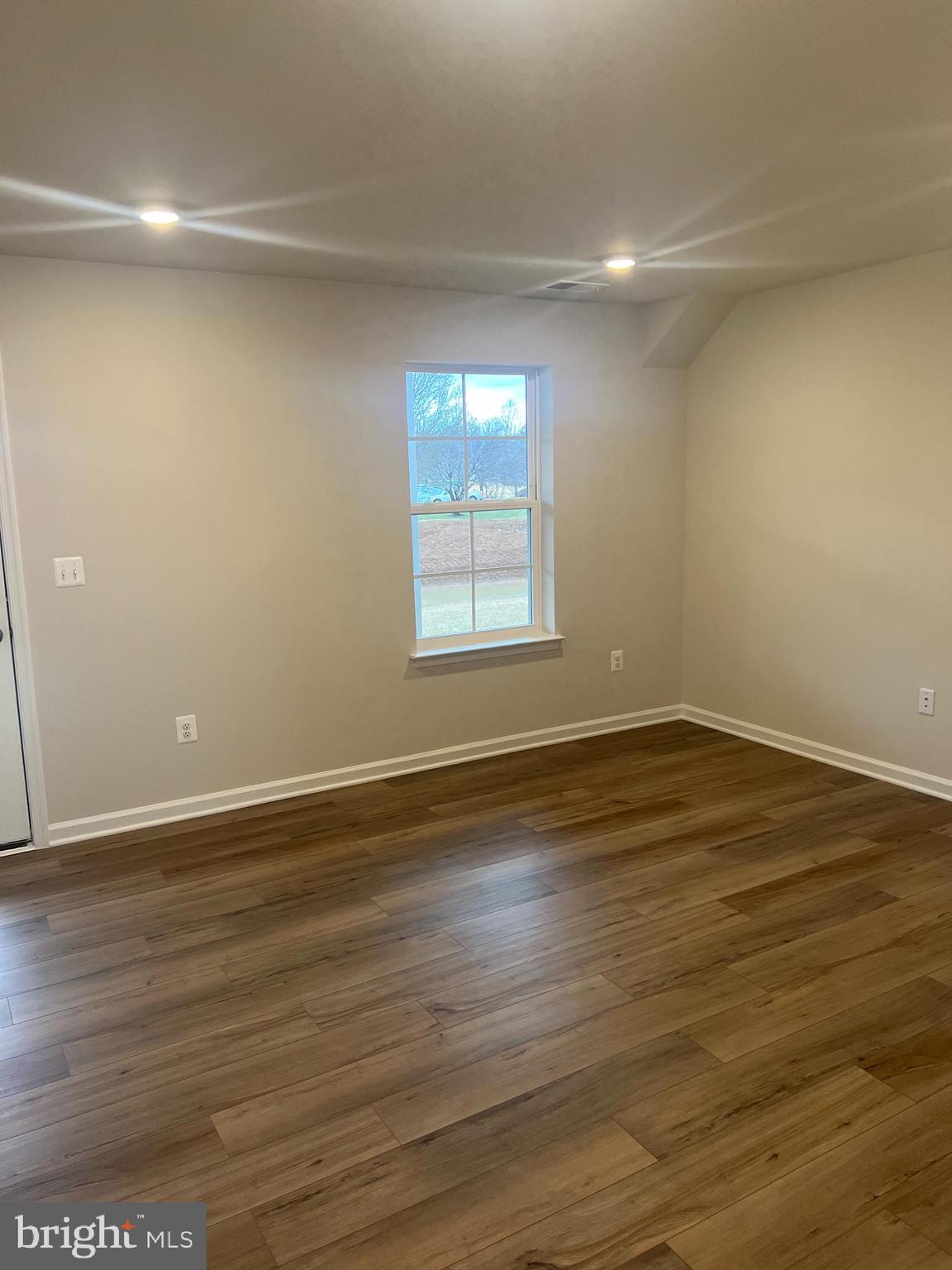 238 Cooperage Road Inwood, WV 25428 - Photo 4 of 27 an empty room with wooden floor and windows