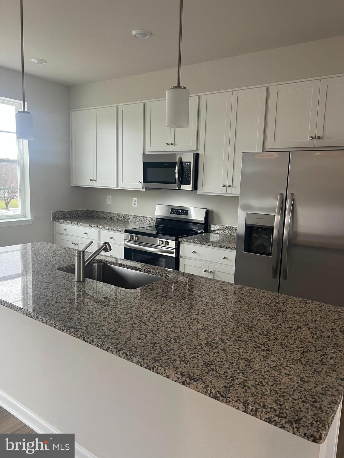 238 Cooperage Road Inwood, WV 25428 - Photo 10 of 27 a kitchen with stainless steel appliances granite countertop a sink a stove and a granite counter top