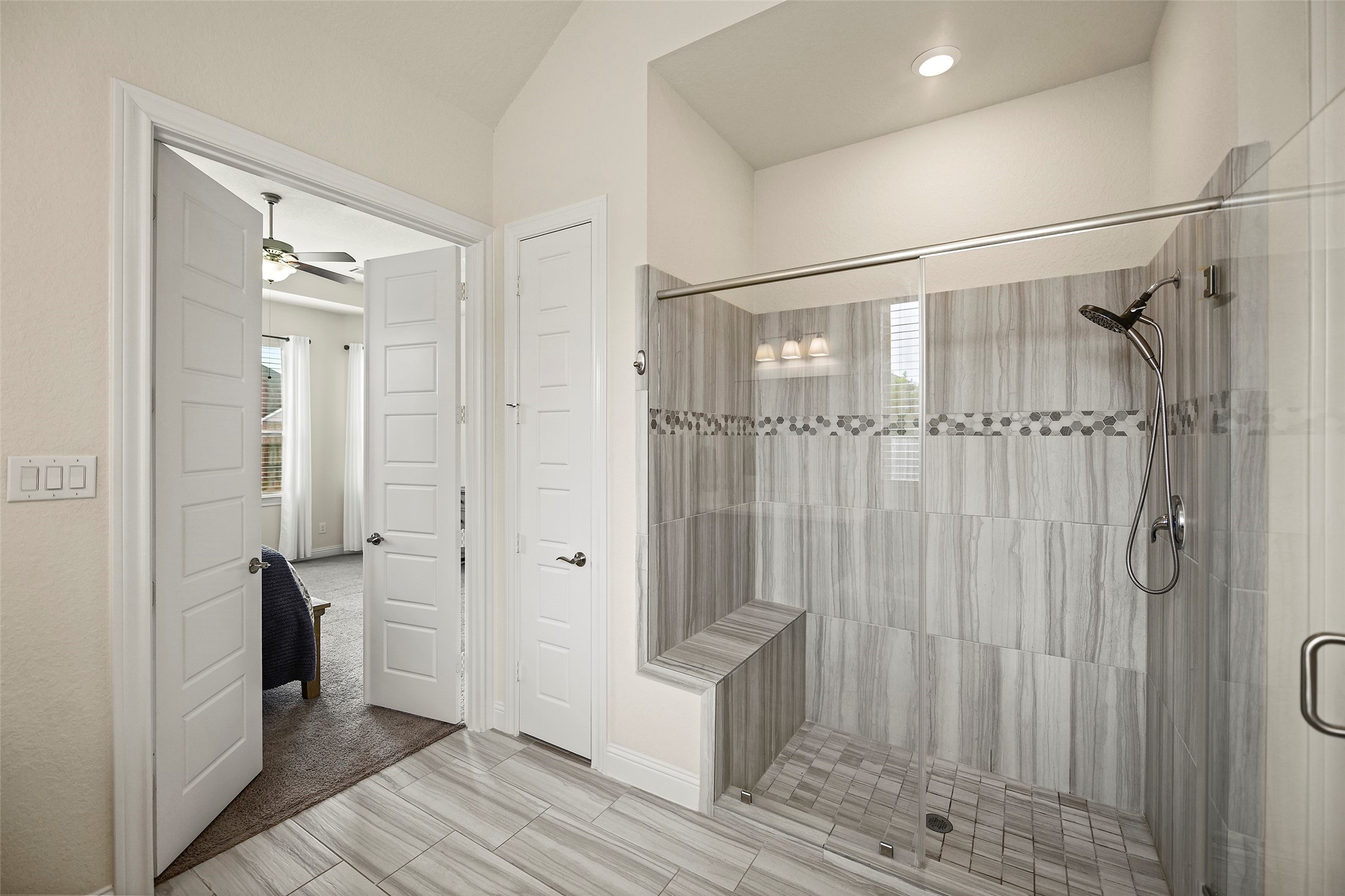 20330 Rosegold Way Spring, TX 77379 - Photo 10 of 48 Oversized walk-in shower with built-in bench seating and elegant tile surround.