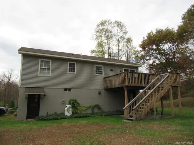 a view of a house with a yard and deck