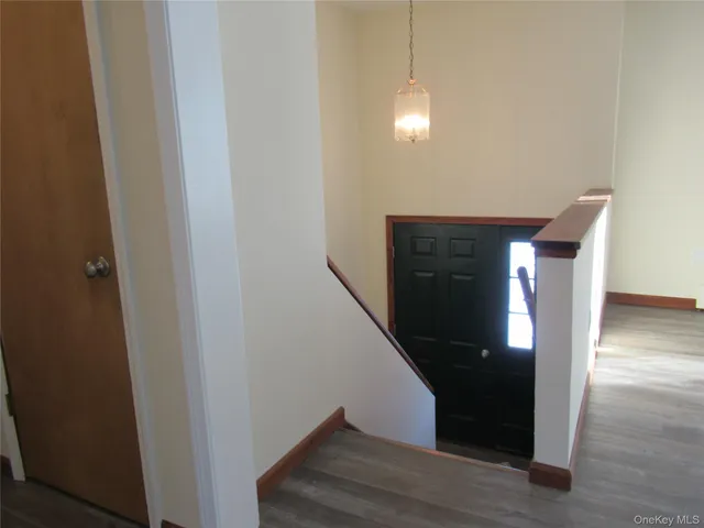 a view of entryway and hall with wooden floor