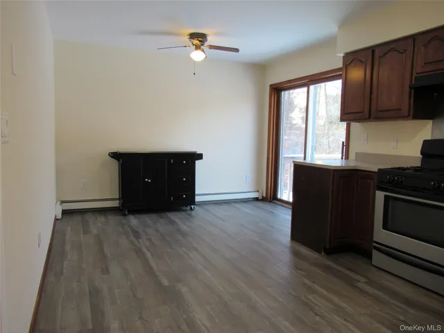 an empty room with wooden floor and window