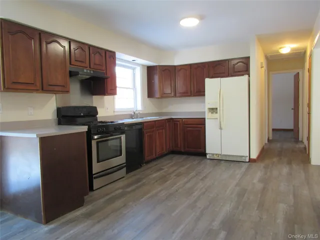 a kitchen with a stove a sink and a refrigerator