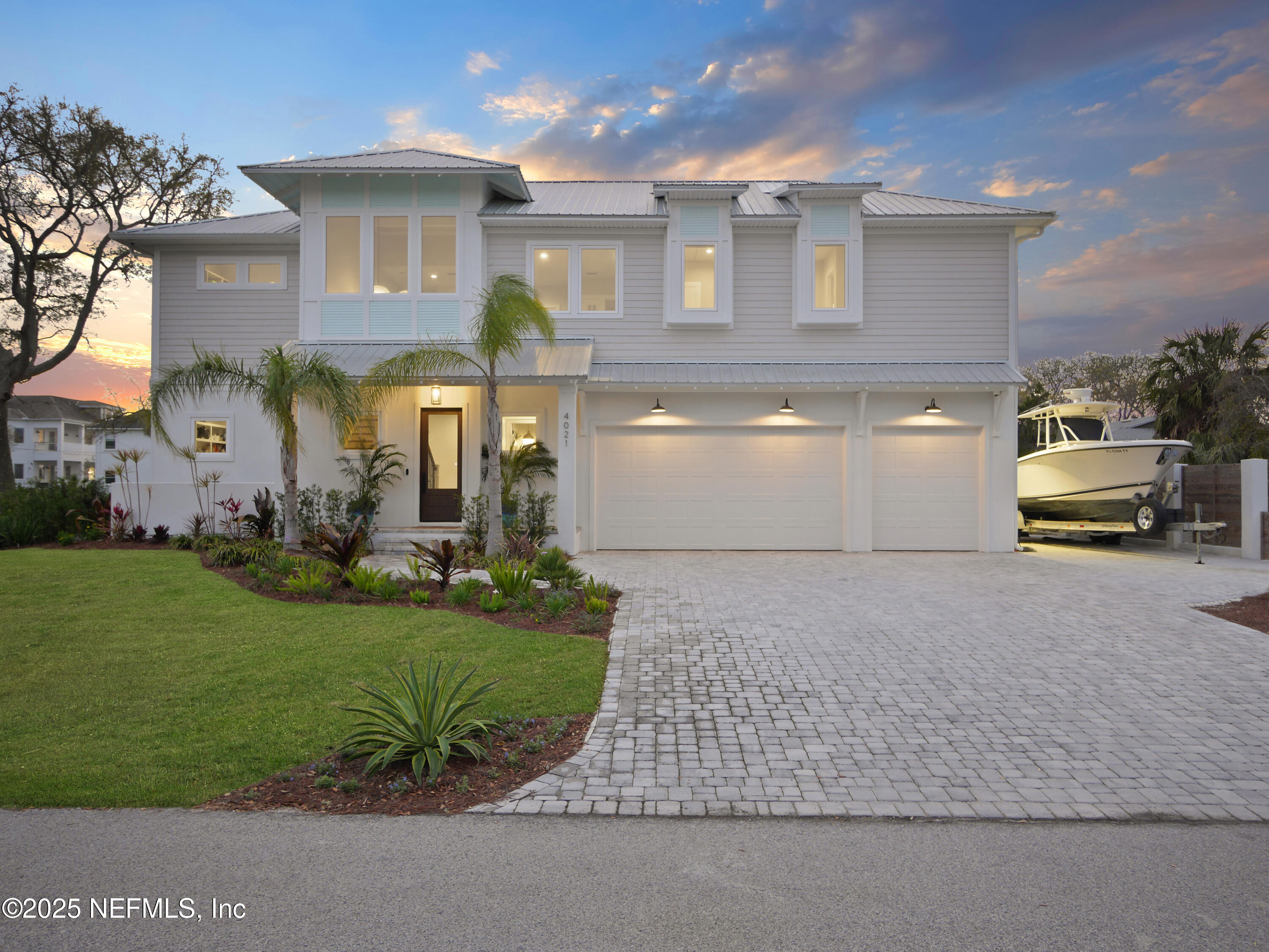 a front view of a house with a garden and parking