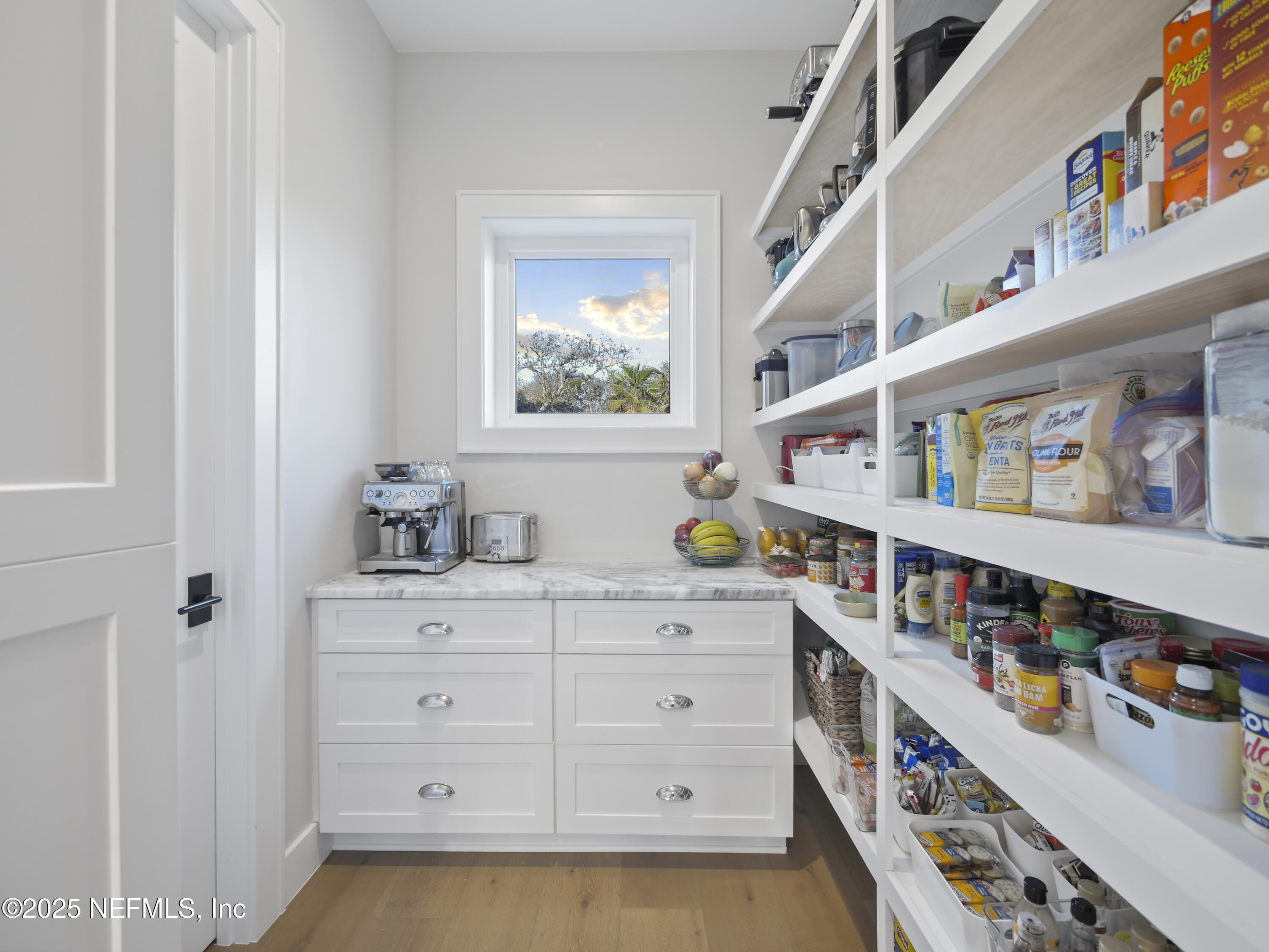4021 Myrtle Street St. Augustine, FL 32084 - Photo 17 of 68 a room with lot of cabinets and a window