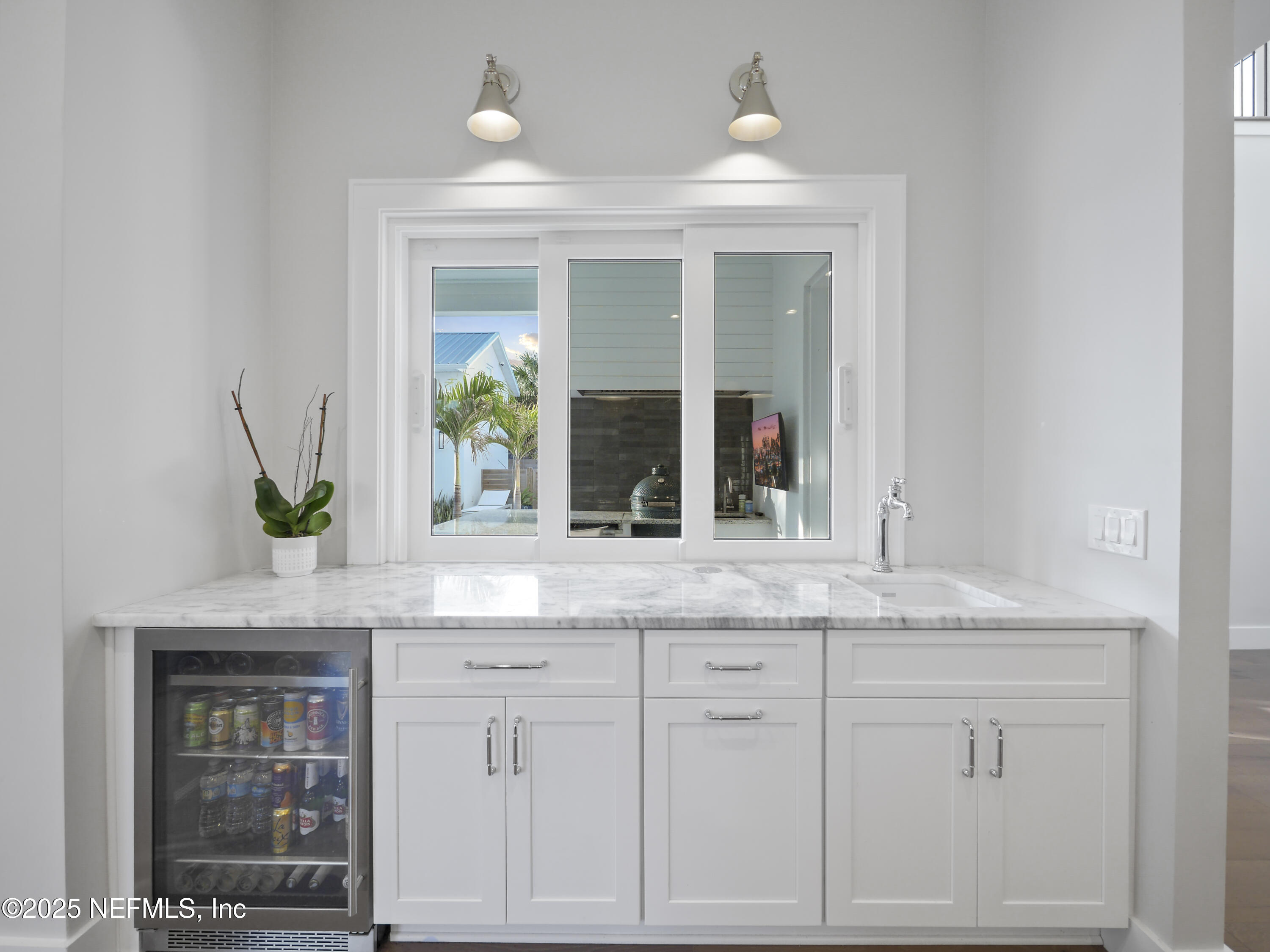 4021 Myrtle Street St. Augustine, FL 32084 - Photo 19 of 68 a sink with white cabinets and potted plant