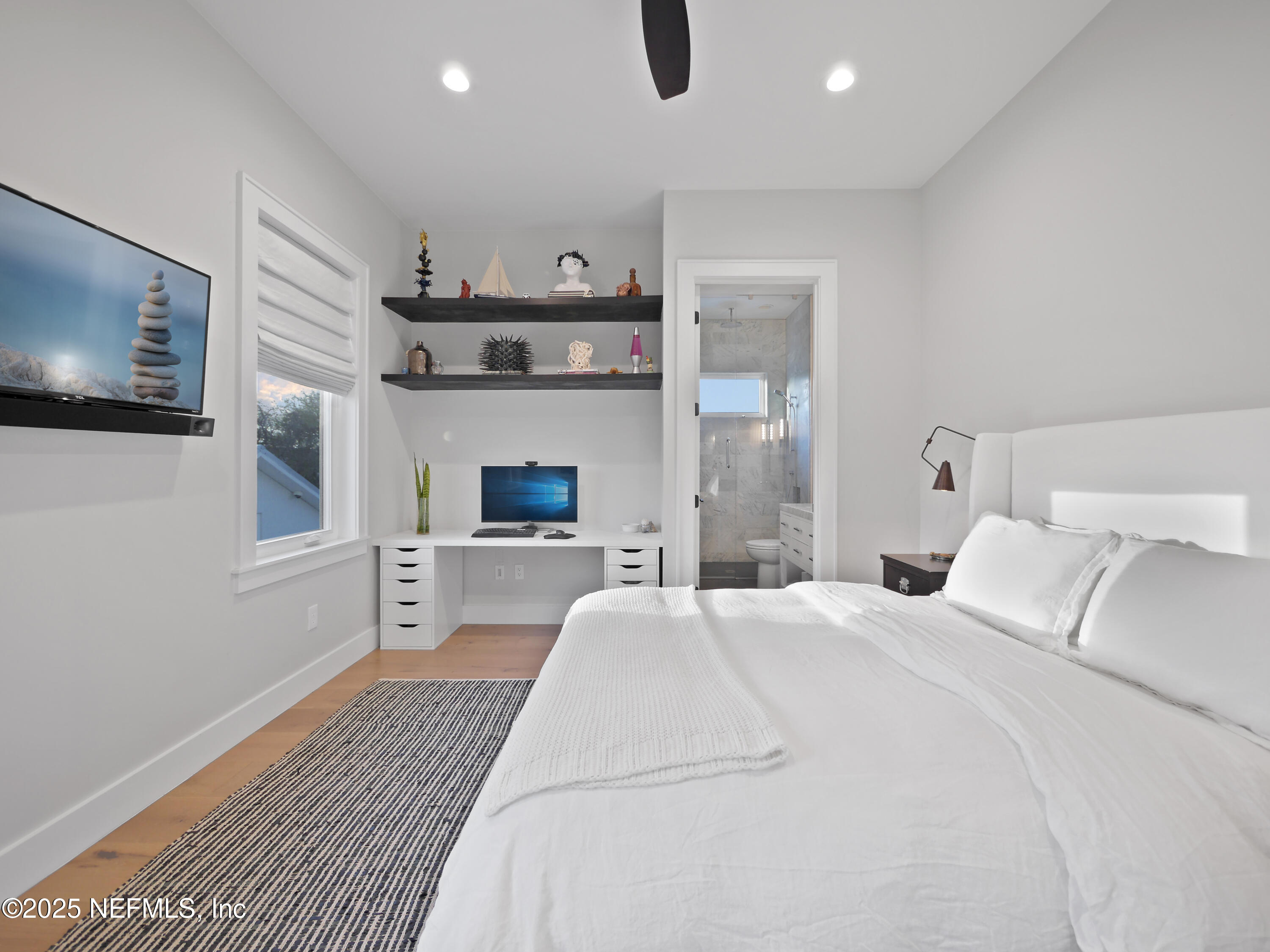 4021 Myrtle Street St. Augustine, FL 32084 - Photo 40 of 68 a bedroom with a large bed and a flat screen tv