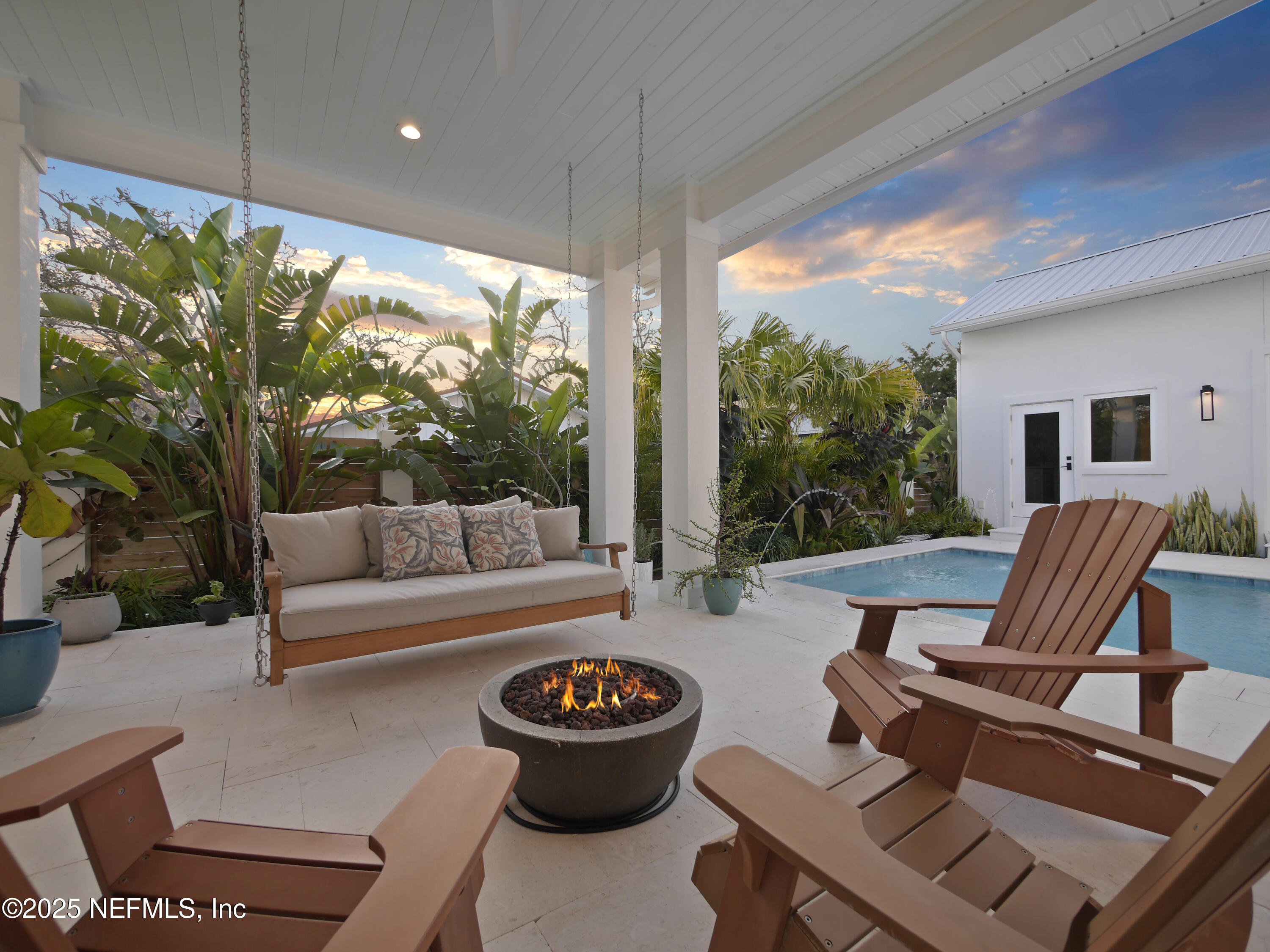 4021 Myrtle Street St. Augustine, FL 32084 - Photo 58 of 68 a living room with patio furniture and a floor to ceiling window