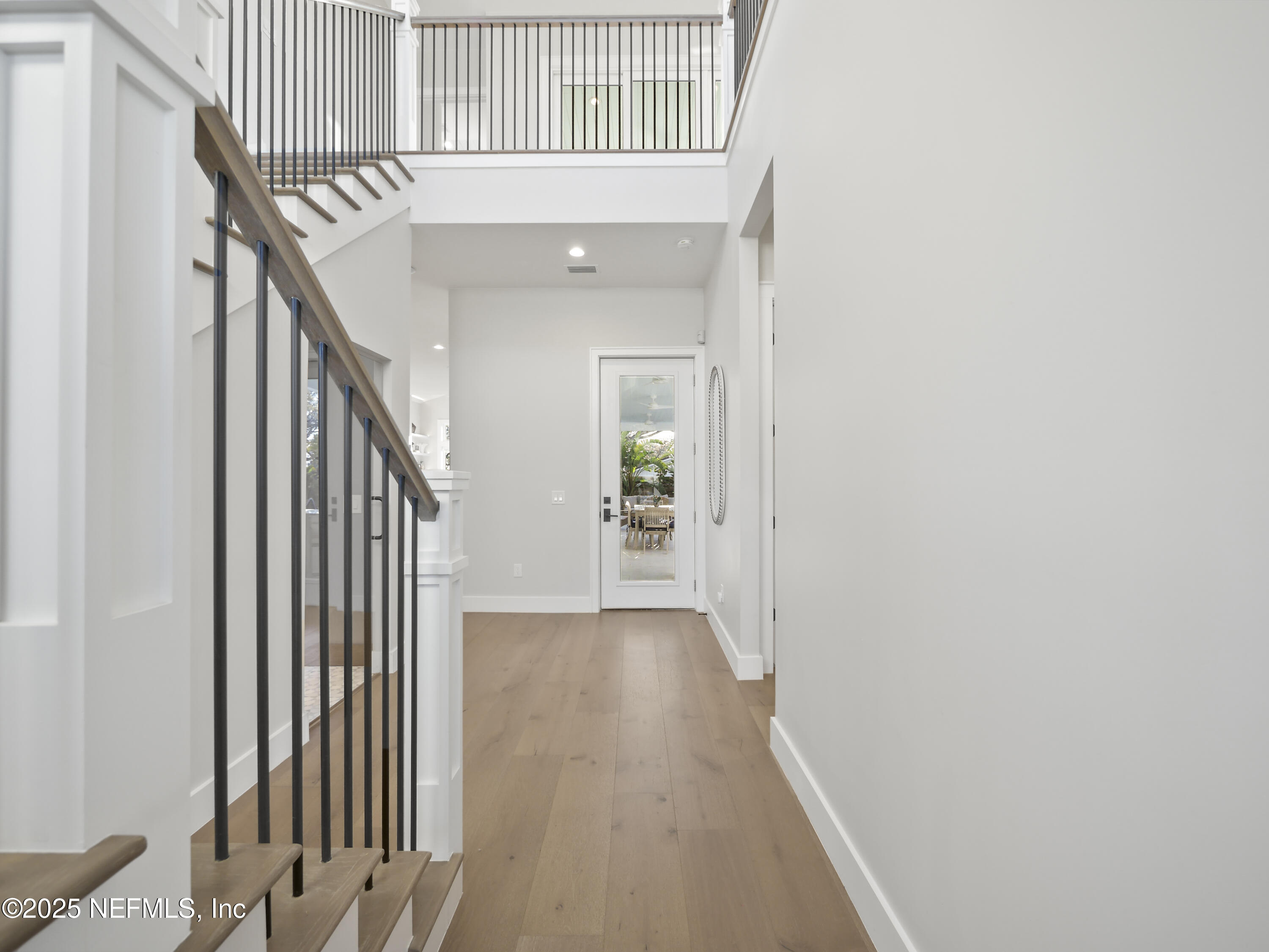 4021 Myrtle Street St. Augustine, FL 32084 - Photo 9 of 68 a view of a hallway with wooden floor and staircase