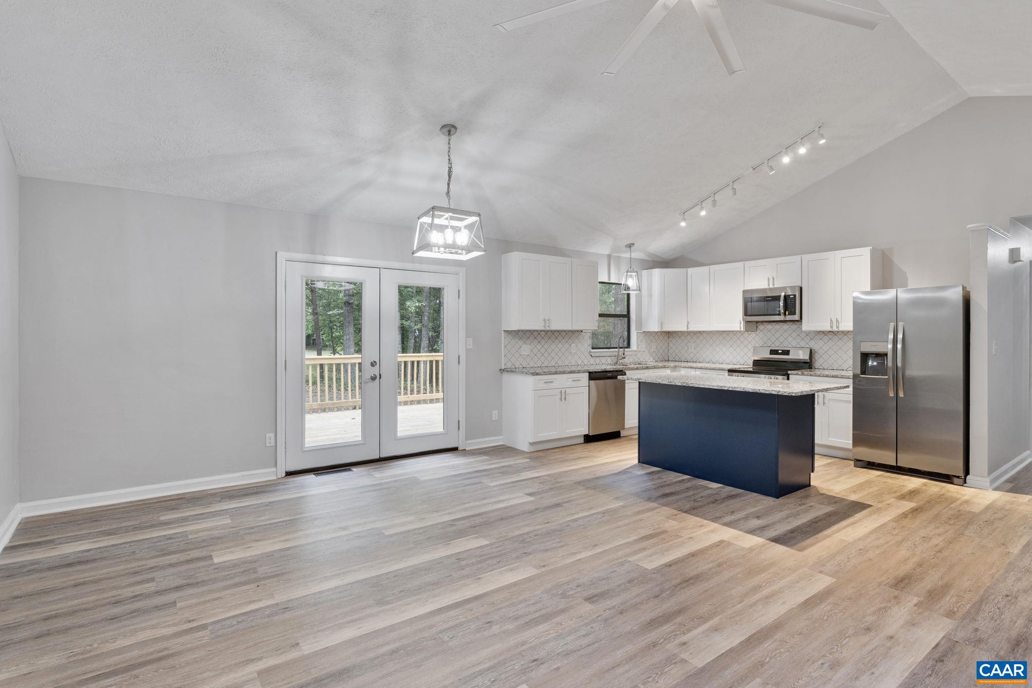 4 Haversack Road Palmyra, VA 22963 - Photo 7 of 36 a large kitchen with stainless steel appliances granite countertop a stove a refrigerator a sink dishwasher a microwave oven with cabinets and wooden floor