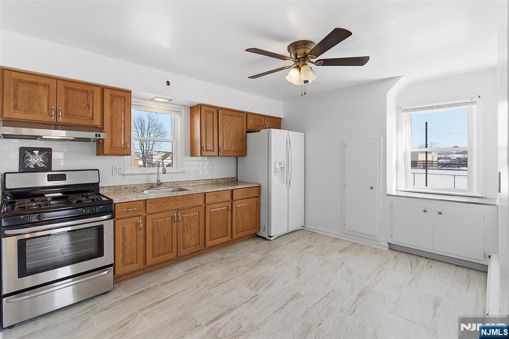 71 Mitchell Street, Unit 2 Lodi, NJ 07644 - Photo 5 of 16 a kitchen with stainless steel appliances a stove a sink and a refrigerator