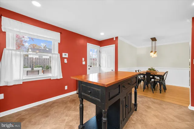 a kitchen with stainless steel appliances granite countertop a stove and a dining table