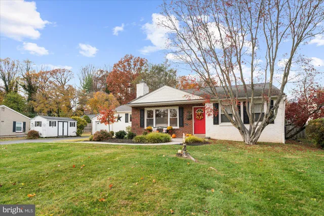 a view of a house with a yard and sitting area