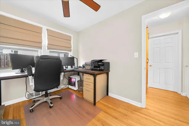 a view of a workspace with furniture and a window
