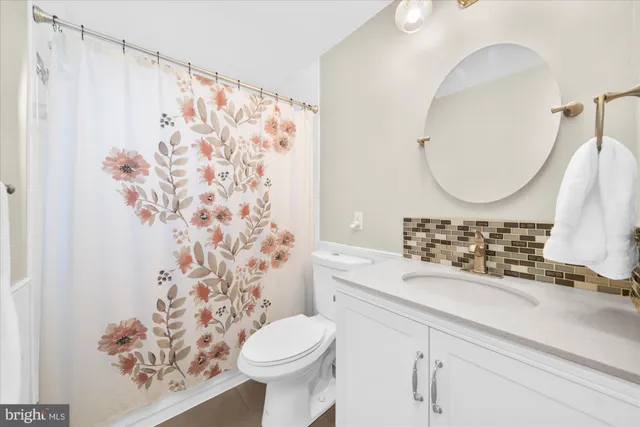 a bathroom with a sink toilet and a mirror