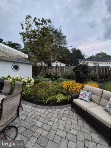 a view of a couches in patio of back yard