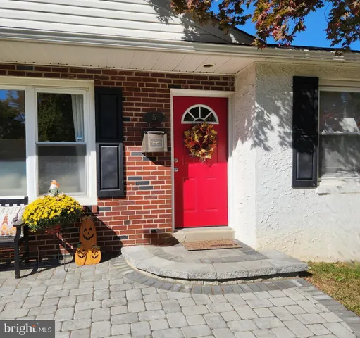 a front view of a house with outdoor seating