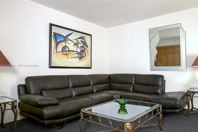 a living room with furniture a rug and a window