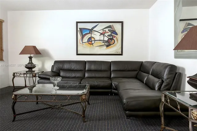 a living room with furniture and a lamp