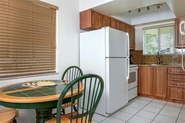 a kitchen with stainless steel appliances granite countertop a refrigerator and a stove