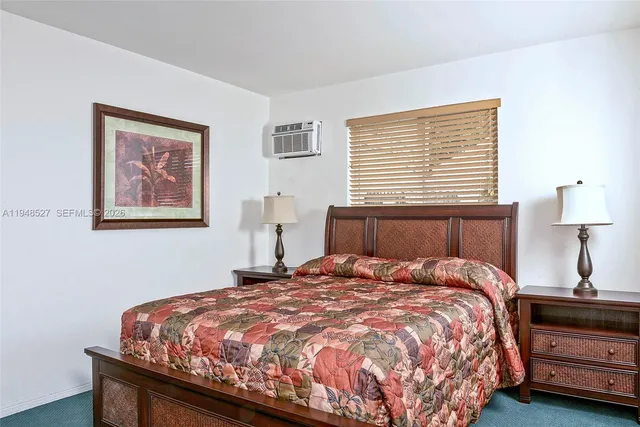 a bedroom with a bed and a night stand