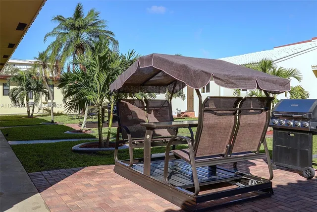 a view of a chairs and table in backyard