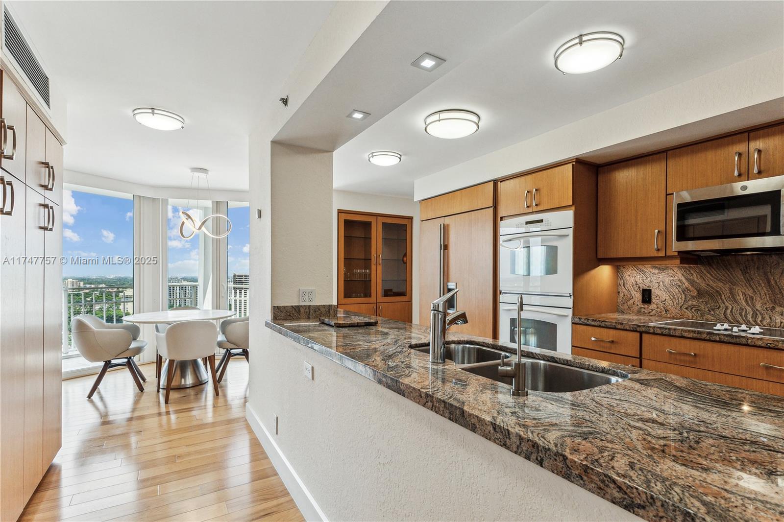 4000 Towerside Terrace, Unit TS3 Miami, FL 33138 - Photo 16 of 49 a living room with stainless steel appliances granite countertop furniture a rug and a large window
